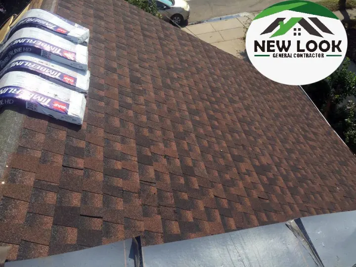 Brown shingle roof with bundles of new shingles